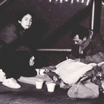 WomanFeedingManonStreet_TN