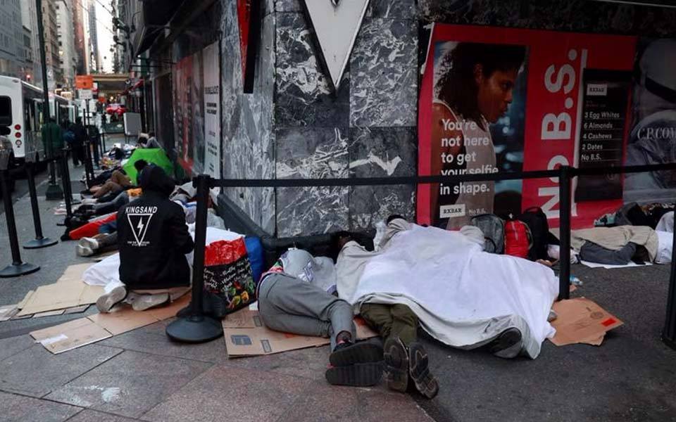 People sleeping on a city street.